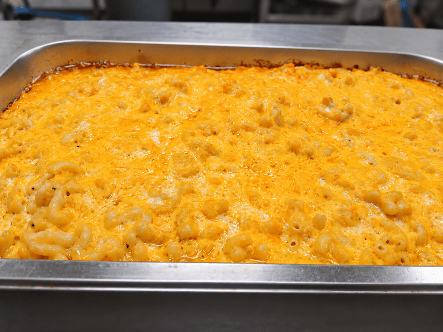 Baked macaroni and cheese in a catering pan